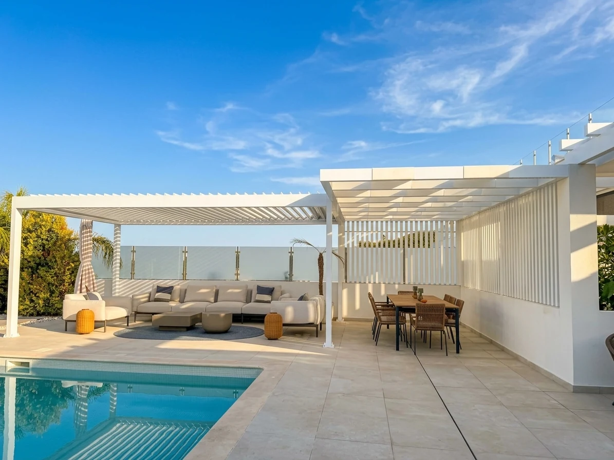 White pergolas shading poolside lounge and dining areas